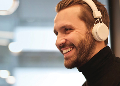 Man smiling with headphones on